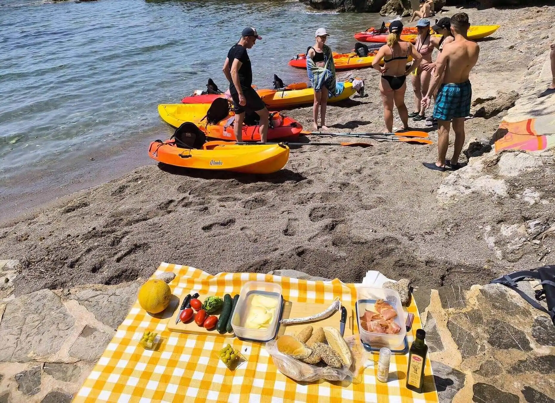 A picnic on the beach with local organic products during a kayak trip in Capdepera, close to Cala Millor